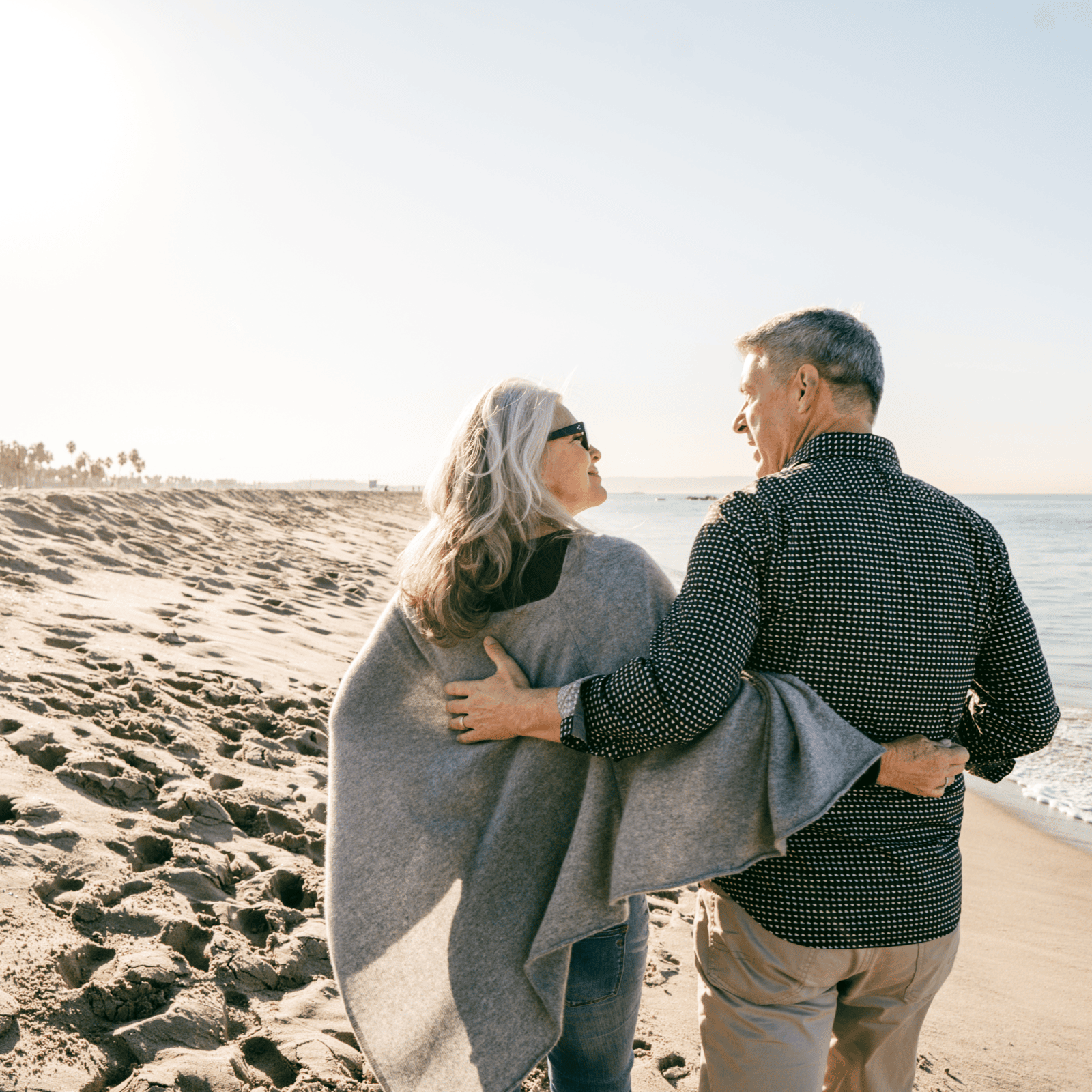 A couple walking by the beach.